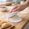 Stampo per empanadas 9,5 cm in uso su piano cucina con mano e ravioli sigillati